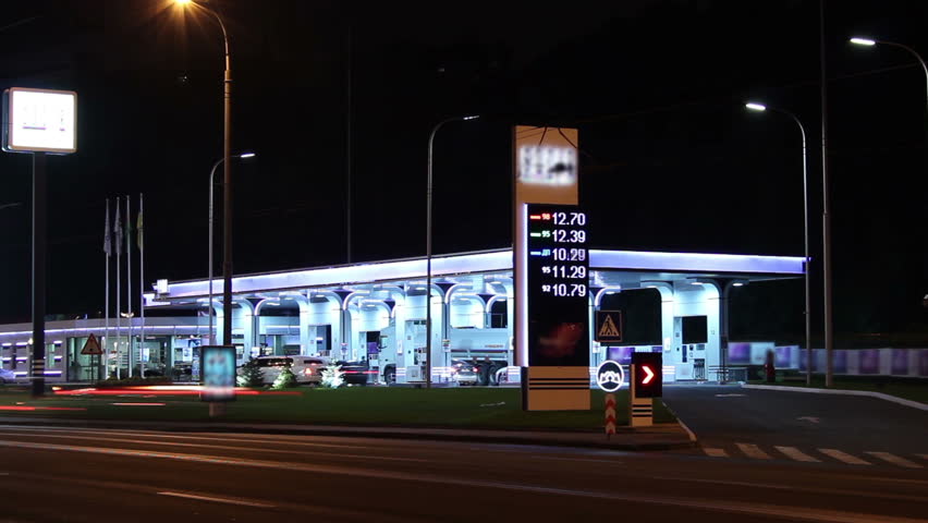 Gas fueling station night timelapse, pertrol service prices list