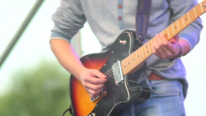 Day show male guitar artist plays hard rock, man instrument
