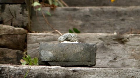 Sledge hammer smashing a concrete block in slow motion