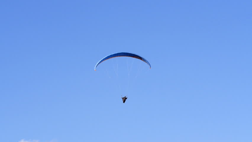 Man paragliding over a hill. HD 1080p