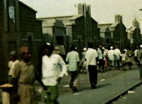 ADEN PROTECTORATE, CIRCA 1960: Public road people driving vintage SD. British Aden Protectorate in southern Arabia.  One of a kind private owned vintage and historic 8mm film. Republic of Yemen.