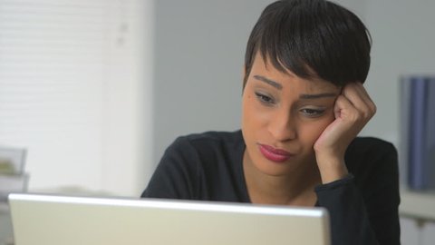 Black business woman expressing frustration at work
