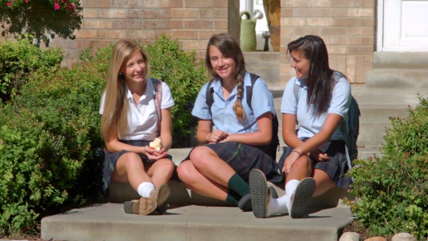 Three Pretty Uniformed Teen School Girls, Sitting & Looking At The Came...