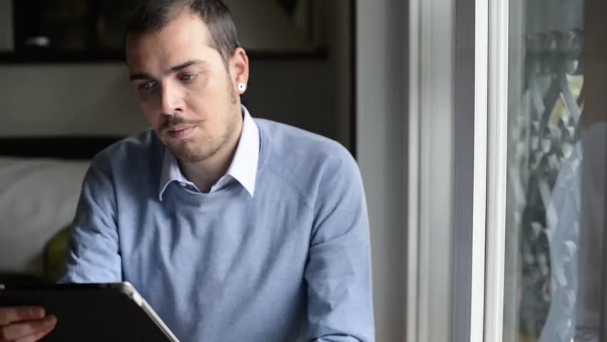 elegant business multitasking multimedia man using notebook at home