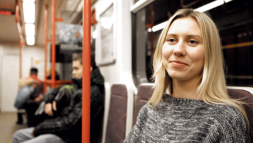 Beautiful young woman seat in vagon subway    