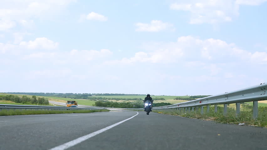 Man sitting on the motorcycle and moving on the road.