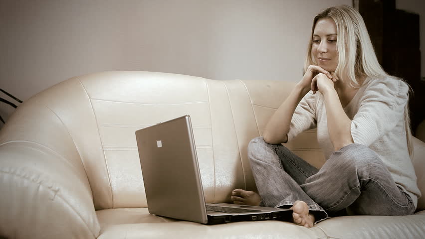 Beautiful girl on sofa with the laptop
