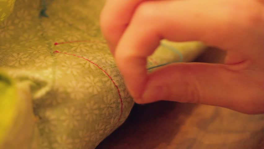 A woman sewing a Christmas advent calendar