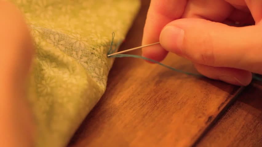 A woman sewing a Christmas advent calendar