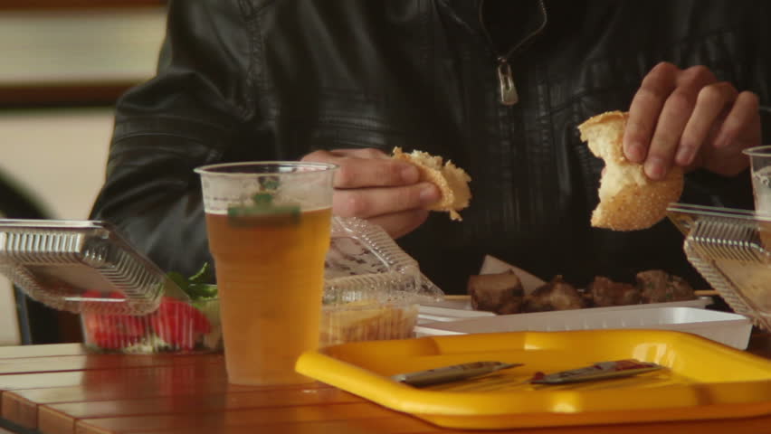 Man eating fast food restaurant meal, burgers meat beer, dining