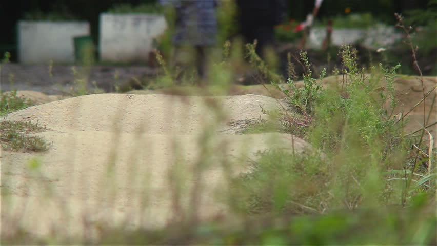 BMX circuit race riders test track ground before challenge begin