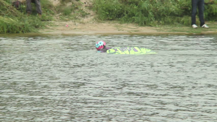 Fallen wake boarder swims back shore with board helmet failed