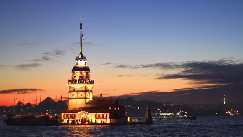 Istanbul Maidens Tower (KIZ Kulesi) from the east in sunset. In the distance are