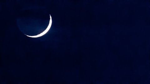 The Moon Down. Nice crescent moon through passing clouds. High definition, Timelapse. 
