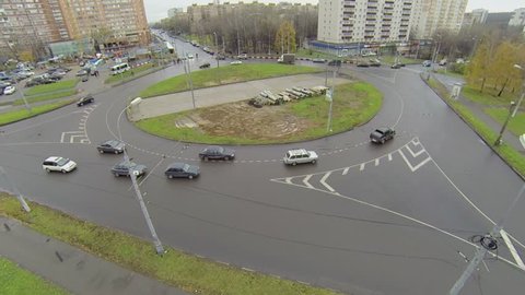 Cars ride by roundabout on Square of Bela Kun at autumn day in Moscow
