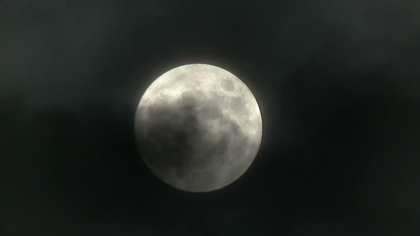 A realtime shot of the full moon on a cloudy night.  Not computer generated.