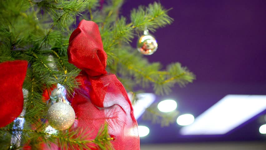 Christmas Balls, Lights and Red Ribbon on Christmas Tree panning shoot Stock