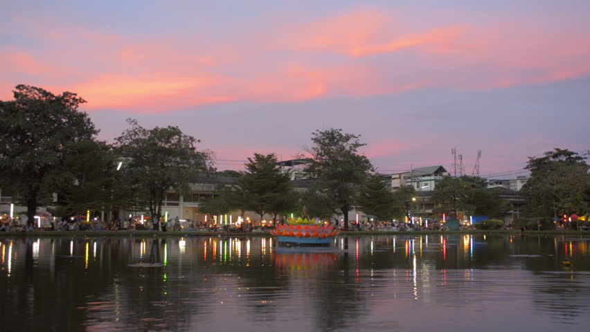 View of Loi Krathong festival celebrations as the sun sets in Bangkok,