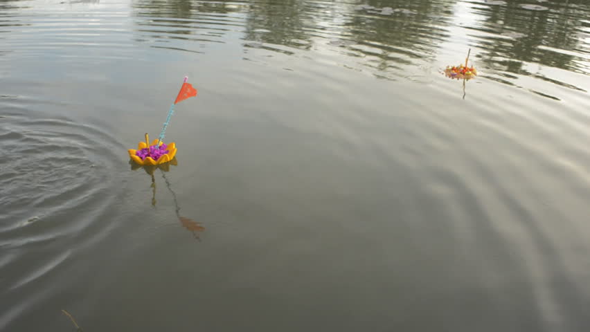 A small krathong made out of bread floats by on a pond in Bangkok, Thailand