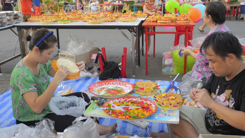 BANGKOK, THAILAND - NOVEMBER 17, 2013:  A Thai family prepping and decorating