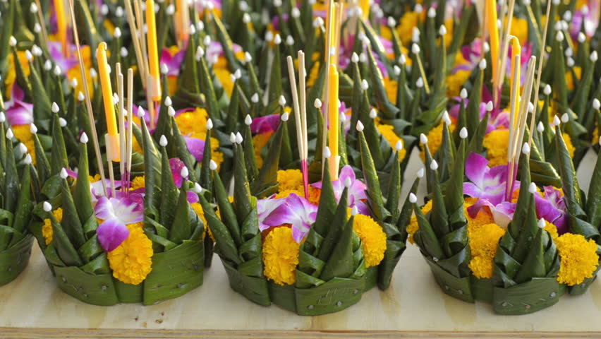 Colorful krathongs, made our of banana leaves and flowers, laid out at a stall