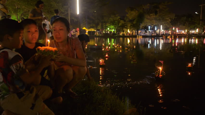 BANGKOK, THAILAND - NOVEMBER 17, 2013: A mother and her sons praying together,