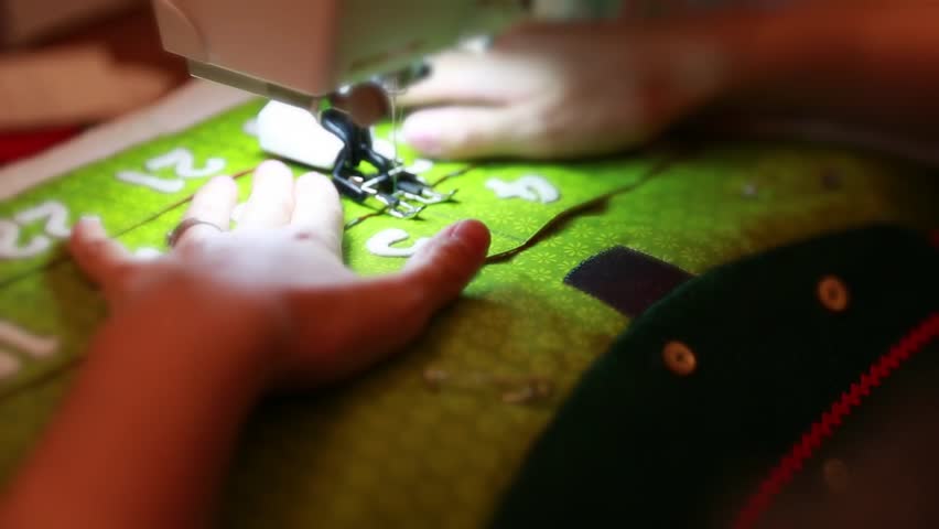 A woman sewing a christmas advent calendar