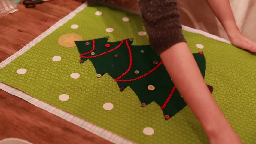 A woman sewing a christmas advent calendar