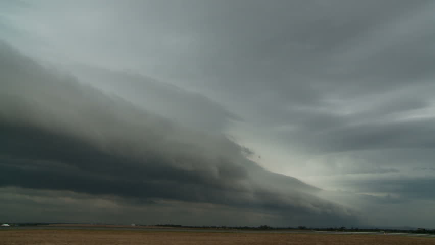  storm front moves across an open field bringing rain. Time Lapse