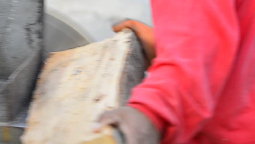 Cutting slices of wood log with a circular saw, close up, sound included