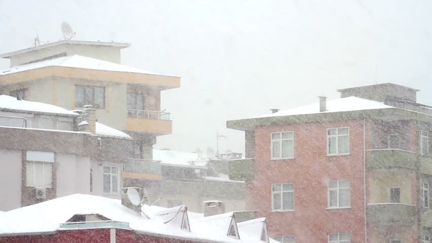 Multi-colored buildings in Istanbul. Snow falling in front of the living block