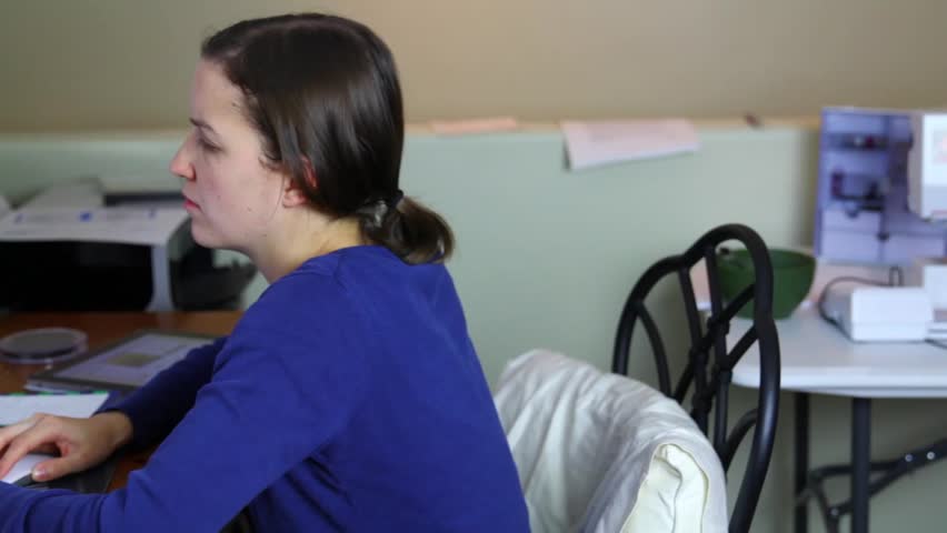 A woman working in a home office on her computer