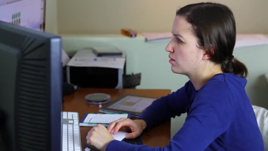 A woman working in a home office on her computer