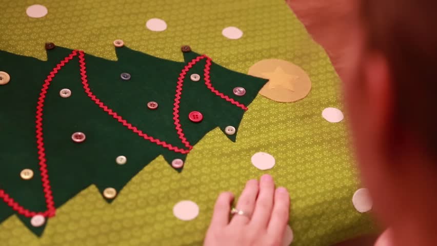 A woman sewing together an advent calendar