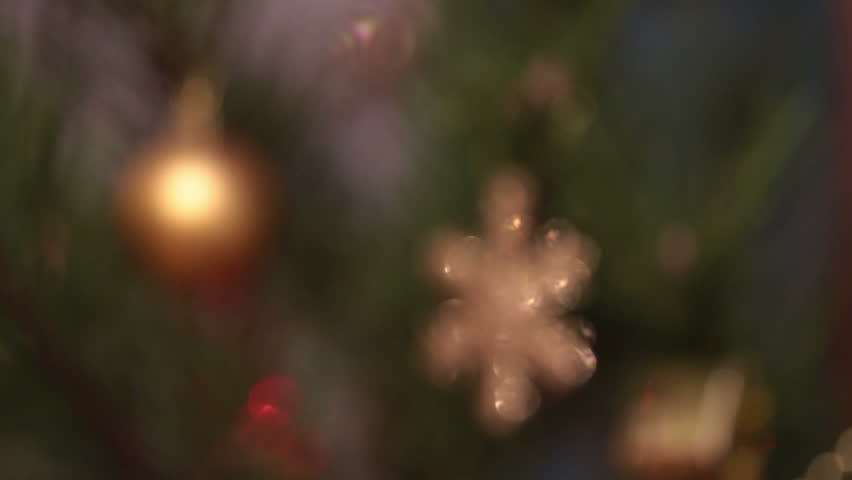defocused decorated christmas tree with flashing garlands