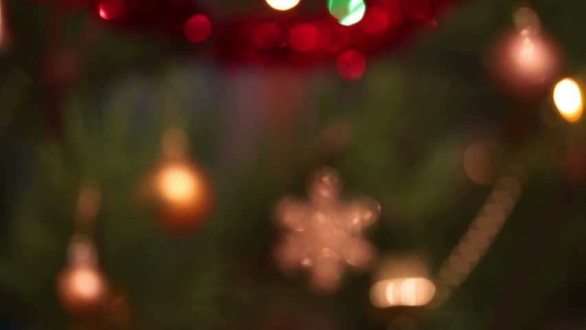defocused decorated christmas tree with flashing garlands