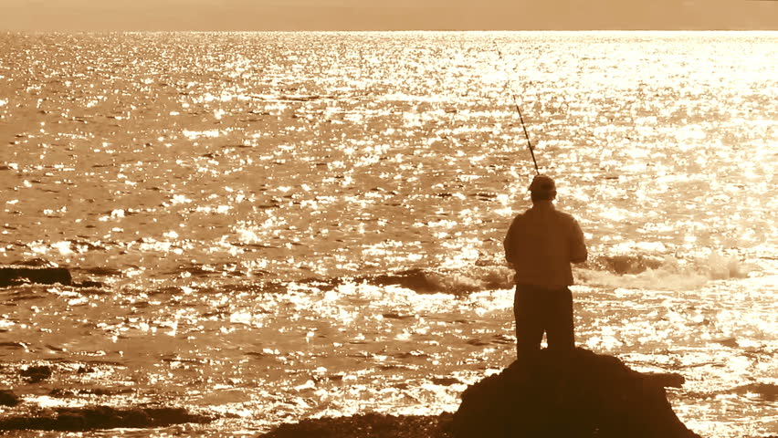 fisherman with spinning silhouette at sea sunset