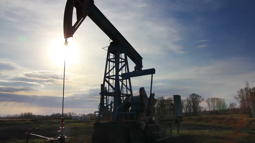 working oil pump at sunset