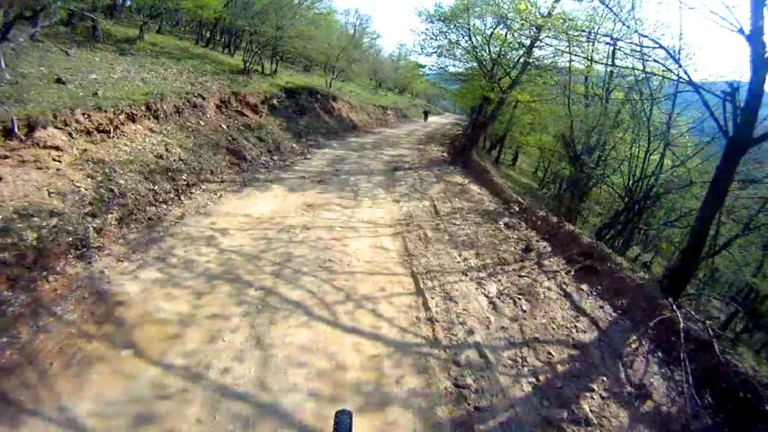 Mountain bike downhill sport race Stock Video. Back view of the other biker pov