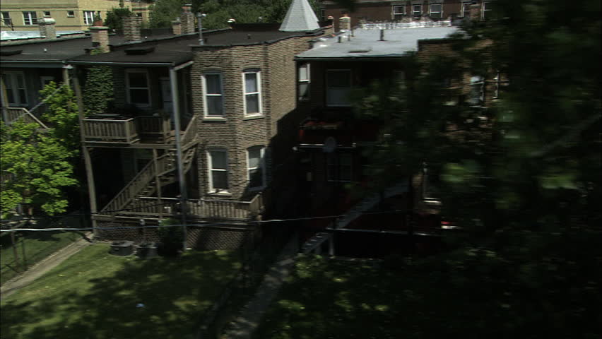 Old buildings in Chicago as seen from the window of a moving elevated train