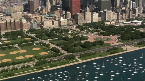 Aerial shot from a helicopter, of Grant Park in Chicago with Buckingham Fountain and lake Michigan visible