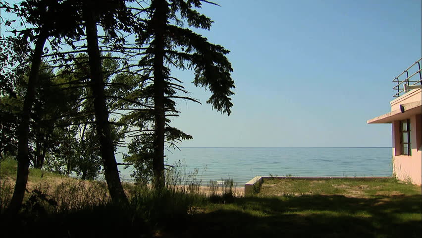 An old abandoned house sits on the edge of Lake Michigan