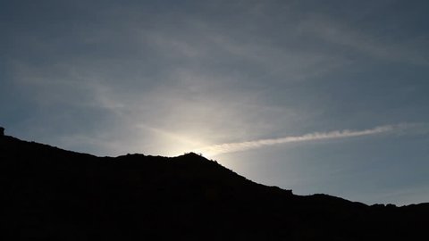 Sunrise over the mountain horizon. Time lapse. Natural lens flares.