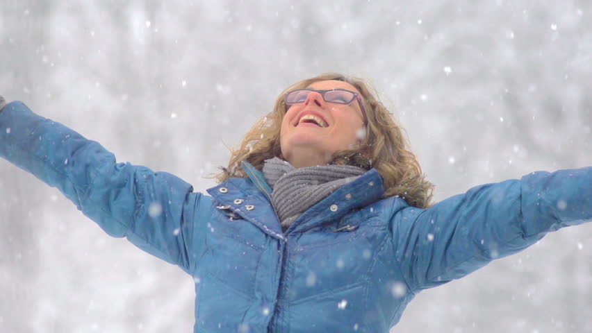 Slow Motion Of A Woman Smiling While Snowflakes Are Falling On Her.  

 