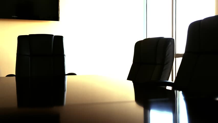A dolly shot of the chairs in a professional business conference room