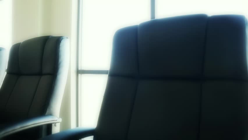 A dolly shot of the chairs in a professional business conference room