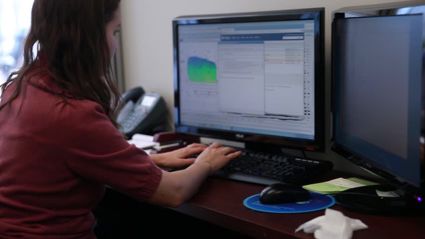 A woman geologist working on her computer in the office