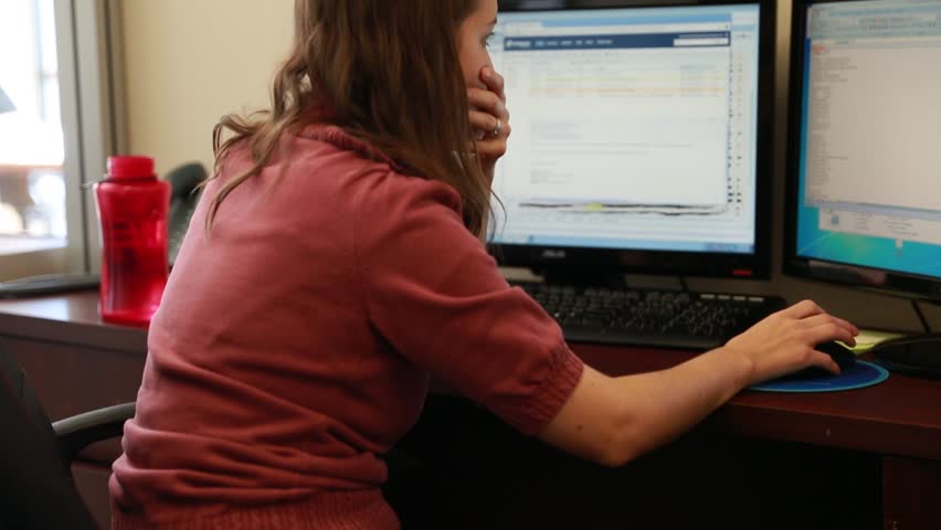 A woman geologist working on her computer in the office