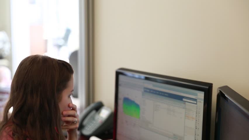 A woman geologist working at the office on her computer