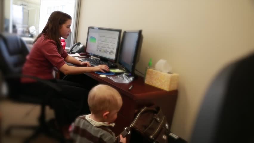 A working mother with her baby boy at the office
